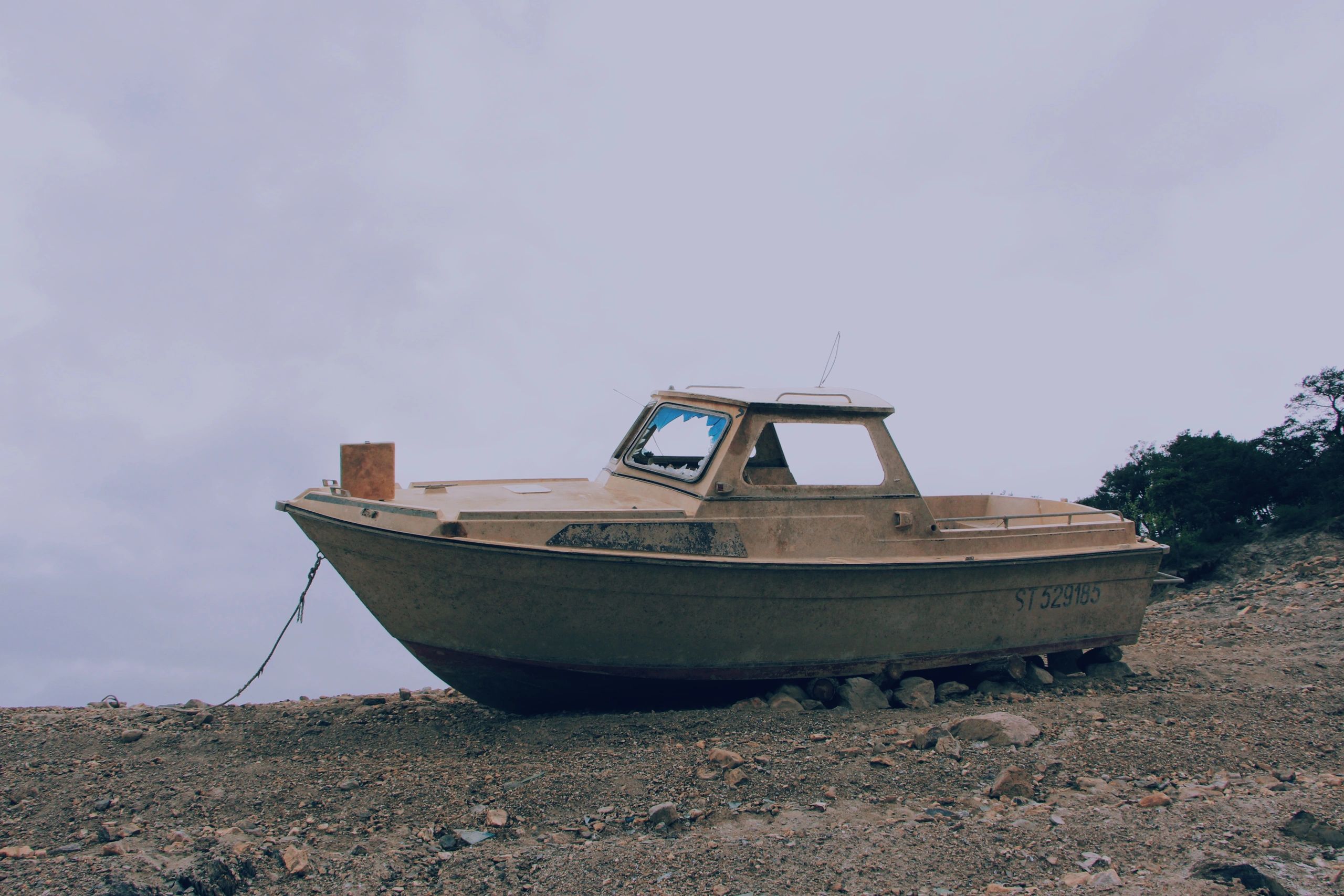 Vintage wooden runabout resting ashore