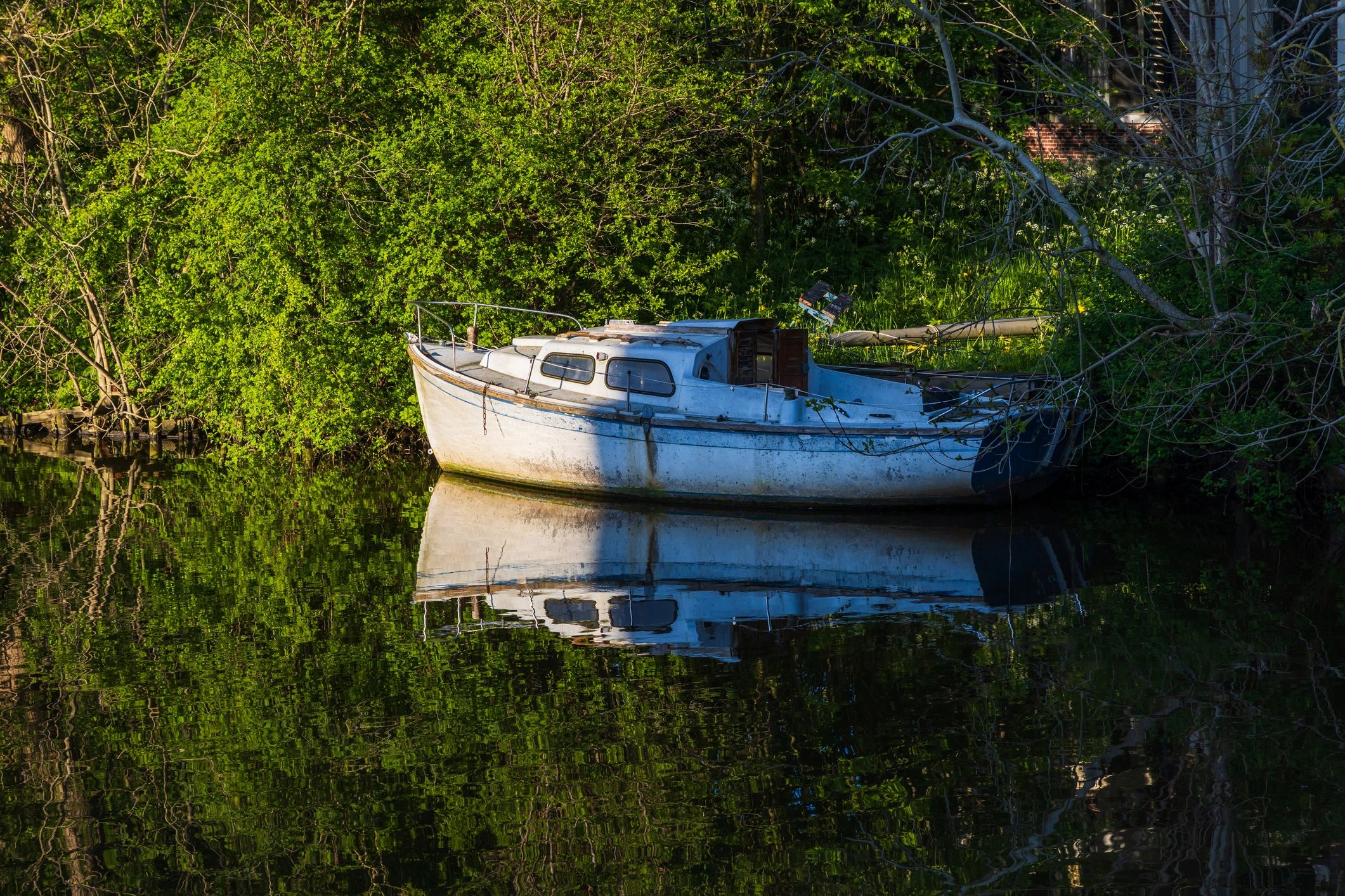 Restored vintage boat moored by the water